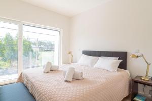 ein Schlafzimmer mit einem großen Bett mit Fenster in der Unterkunft Villa Cuca in Aroeira + 25 Fotos