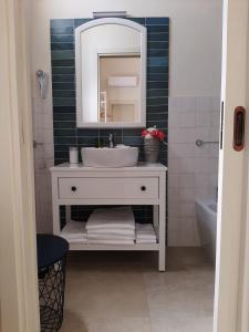 a bathroom with a white sink and a mirror at B&B Fiore in Gallipoli