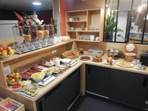 a kitchen filled with lots of different types of food at Apparthotel Privilodges Carré de Jaude in Clermont-Ferrand