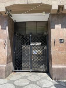 a metal gate in a building with the number at Lift Rooms in Odesa