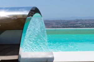 a surfboard sitting on top of a table next to the water at Barefoot Summer House in Klis