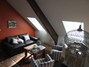 a living room with a couch and a table at Mansion Victorine in Honfleur