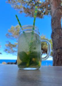a mason jar filled with a drink on a table at Villa Les Glycines in Les Issambres