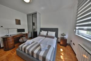 a bedroom with a large bed with a desk and a bed sidx sidx sidx sidx at Luxurious apartment in Belgrade in Belgrade