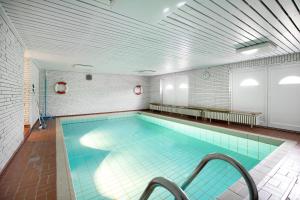 a large indoor swimming pool with a tile ceiling at Ferienwohnung Haus Lazy Dolphin in Rantum