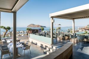 a restaurant with a view of the ocean at Porto Platanias Beach Resort & Spa in Plataniás