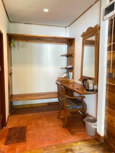 a home office with a desk and a mirror at Coconut Lanta Resort @Klong Dow beach in Krabi town