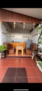 a living room with couches and a table on a floor at CSLTDL Quỳnh Nhi in Da Lat