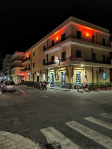 a large building on the side of a street at night at Fantasia BeB APARTAMENT STUDIO in Pellaro