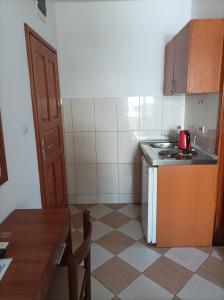 a small kitchen with a sink and a stove at Apartmani Baštrica in Budva