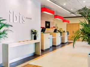 a lobby of a ups clinic with potted plants at Ibis Izmir Alsancak in İzmir