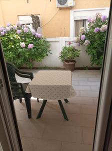 a table and chairs on a patio with flowers at Apartmani Baštrica in Budva