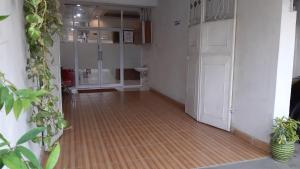 an empty hallway with a shower and a wooden floor at Homestay Legundi Syariah in Tanjungkarang