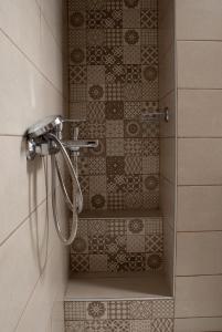 a shower in a bathroom with tiles on the wall at AFISSOS SEASIDE STUDIOS in Afissos