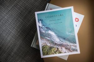 a book sitting on top of a table at QT Queenstown in Queenstown