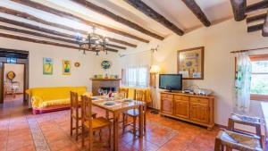 a living room with a table and a tv at Casa Los Olivos Orgiva by Ruralidays in Órgiva