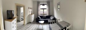 a small living room with a couch and a tv at Fewo Rico 3 in Quedlinburg