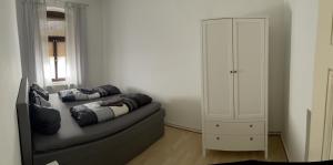 a living room with a couch and a white cabinet at Fewo Rico 3 in Quedlinburg