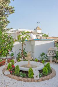 a garden with a fountain in front of a building at Villa Costa Marbella in Marbella