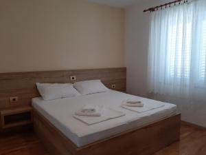 Postel nebo postele na pokoji v ubytování Apartments EDO