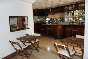 a restaurant with wooden tables and chairs and a bar at Hotel La Riviera in Albir