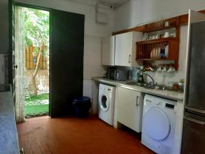 a kitchen with a washing machine and a washer at Finca El Naranjo in Seville