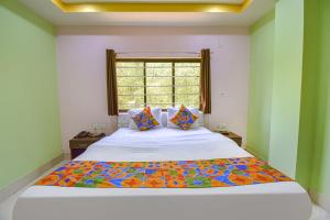 um quarto com uma cama grande e uma janela em FabHotel Knight Airways em Guwahati