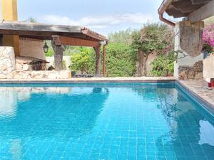 a swimming pool in a house with blue water at Coral Riviera Sardinia villa & cottage in Alghero