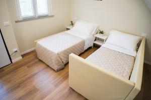 Postel nebo postele na pokoji v ubytování Balconi Del Conero