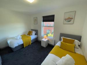 a bedroom with two beds and a window at ED Executive Ipswich Accommodation in Ipswich
