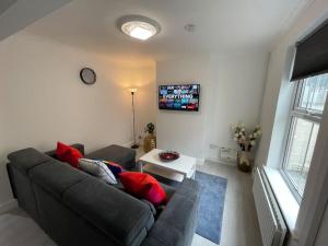 a living room with a couch and a tv at ED Executive Ipswich Accommodation in Ipswich