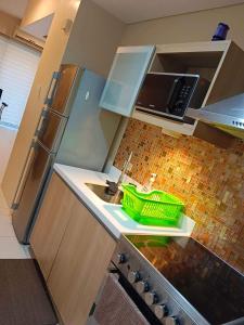 a kitchen with a green basket on a counter at Pico Beach Front Condo in Nasugbu