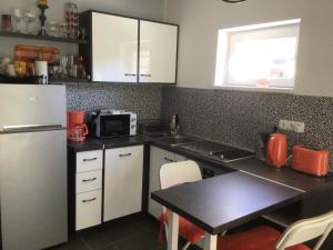 a kitchen with a white refrigerator and a table at Sunset Villa in Siófok