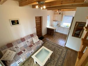 a living room with a couch and a table at Domek apartament w Puszczy Augustowskiej in Płaska
