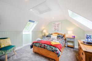 a bedroom with a bed and a chair at Smithy House in Lochgilphead