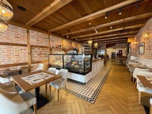 a restaurant with a table and chairs and a brick wall at Apartamenty Rynek23 in Puck