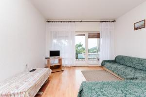Televízia a/alebo spoločenská miestnosť v ubytovaní Apartments Mladen Jelica