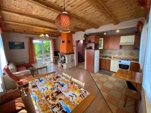 eine Küche und ein Wohnzimmer mit einem Tisch im Zimmer in der Unterkunft Bociani Domek in Płaska