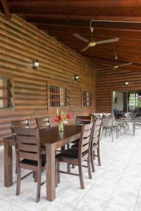 a wooden dining room with a table and chairs at Heliconia Grove in Baie Sainte Anne