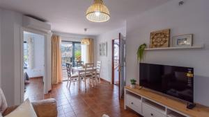 A television and/or entertainment centre at Apartamento Mirasierra 2 Frigiliana by Ruralidays