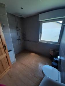 a small bathroom with a window and a toilet at Ferienhaus Schwalbennest in Gerolstein