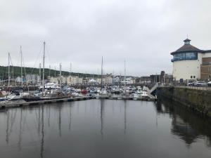 a marina with boats docked in a harbor at Grade II Listed House in the Lake District - Perfect deployment location for Coast to Coast cyclists & hikers in Whitehaven