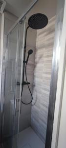 a shower with a shower head in a bathroom at **Studio Holidays** Centre ville 20 m2 in Chalons en Champagne +12 photos