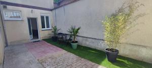 a patio with potted plants on the side of a building at **Studio Holidays** Centre ville 20 m2 in Chalons en Champagne