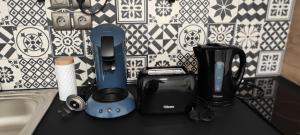 a counter top with various appliances on it at **Studio Holidays** Centre ville 20 m2 in Chalons en Champagne