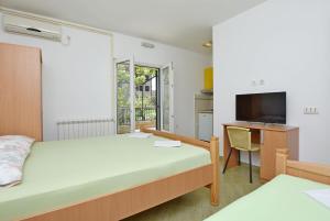 Katil atau katil-katil dalam bilik di Apartments and Rooms Iva