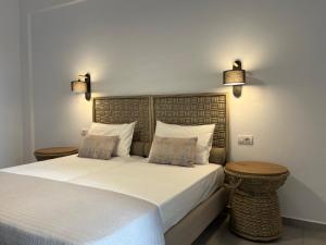 a bedroom with a large white bed with two tables at Margarita Guesthouse in Apollonia