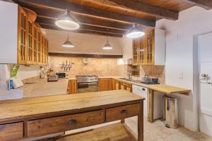a large kitchen with wooden cabinets and wooden counters at Convento de Sao Saturnino in Sintra