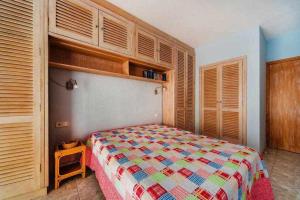 a bedroom with a bed and wooden cabinets at Espanhouse Maestro sea view apartment in Torrevieja