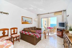 a living room with a couch and a television at Espanhouse Maestro sea view apartment in Torrevieja